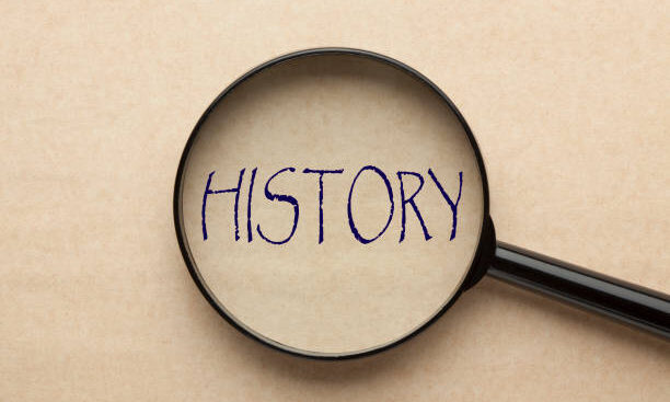 Magnifying glass focusing on HISTORY word. Business concept